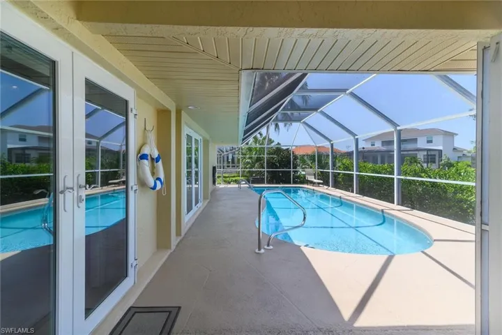 Screened-in outdoor pool with integrated handrails