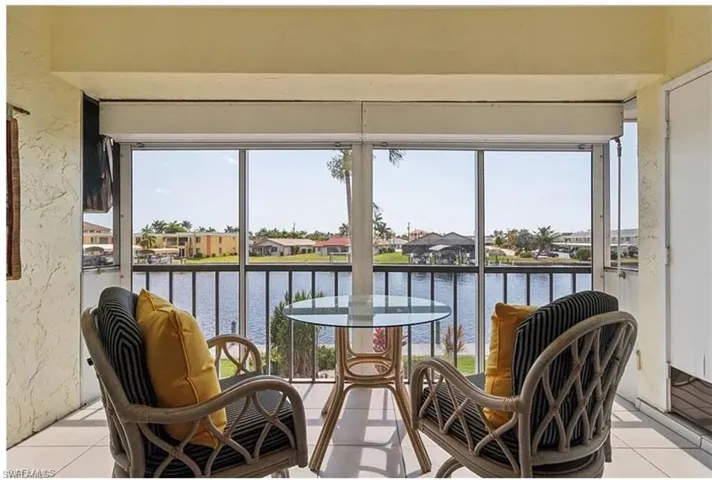 Sunroom / solarium with a water view and a wealth of natural light