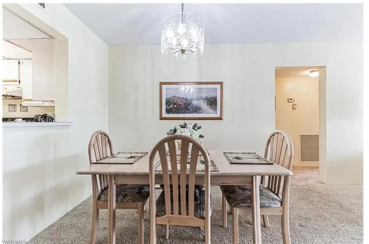 Dining room with an inviting chandelier and carpet