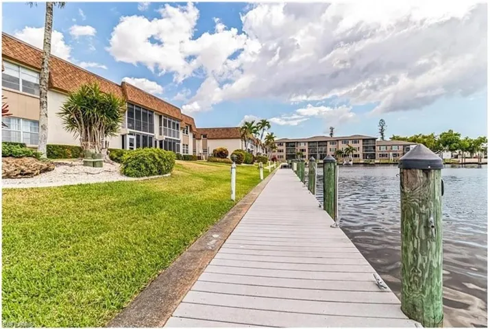 View of dock featuring a water view and a yard