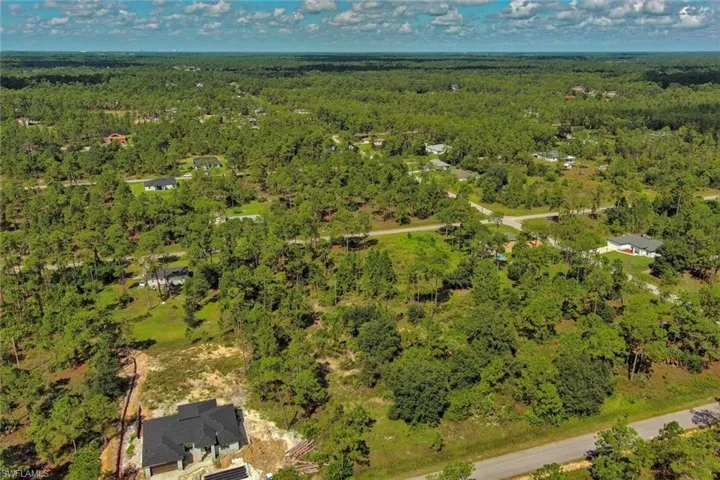 Aerial view of property's location featuring a forest