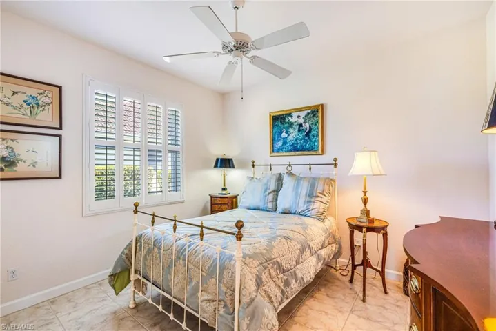 Bedroom featuring ceiling fan and baseboards