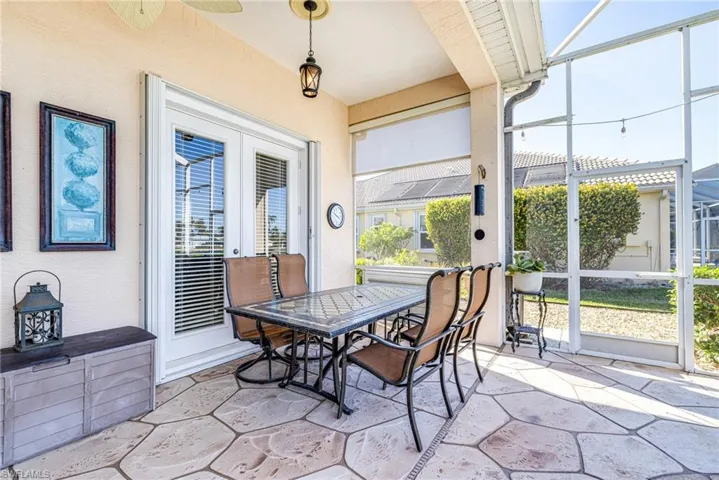 Sunroom / solarium with a patio, outdoor dining area, ceiling fan, and french doors