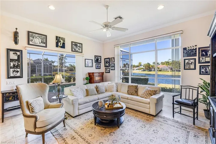 Living area featuring ceiling fan, crown molding, a water view, and recessed lighting