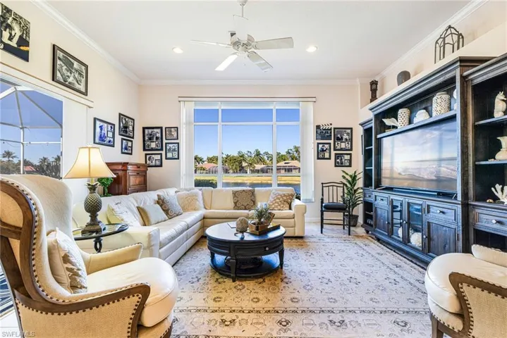 Living area with a ceiling fan, crown molding, and recessed lighting