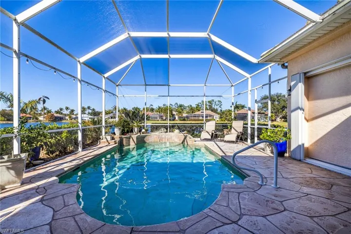 Swimming pool with a lanai, a sunroom, and a patio