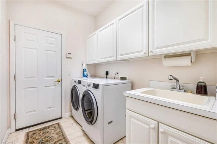 Laundry room with cabinet space and washing machine and dryer