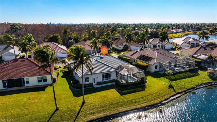Aerial perspective of suburban area with a nearby body of water