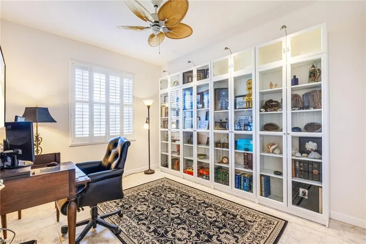 Home office featuring baseboards and a ceiling fan