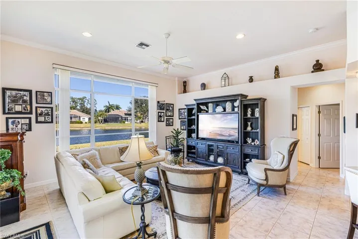 Living room featuring ceiling fan, ornamental molding, and recessed lighting