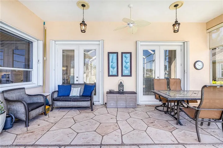 View of patio / terrace with ceiling fan, french doors, and outdoor dining space