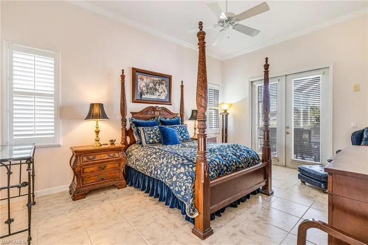 Bedroom with access to outside, crown molding, ceiling fan, and french doors