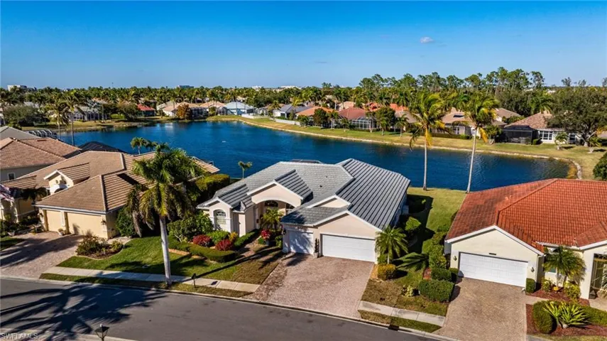 Aerial view of residential area featuring a nearby body of water