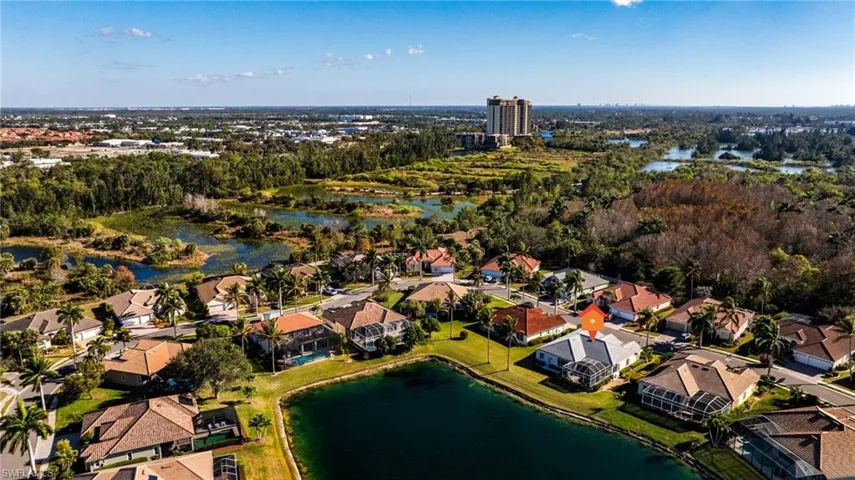 Aerial view of property's location with a nearby body of water and nearby suburban area