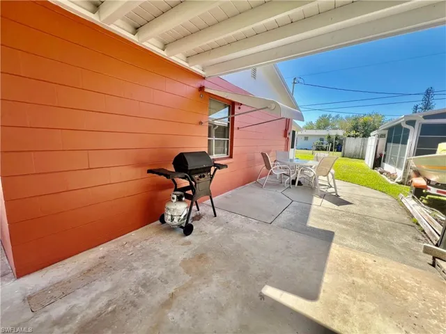 View of patio featuring outdoor dining space and a grill