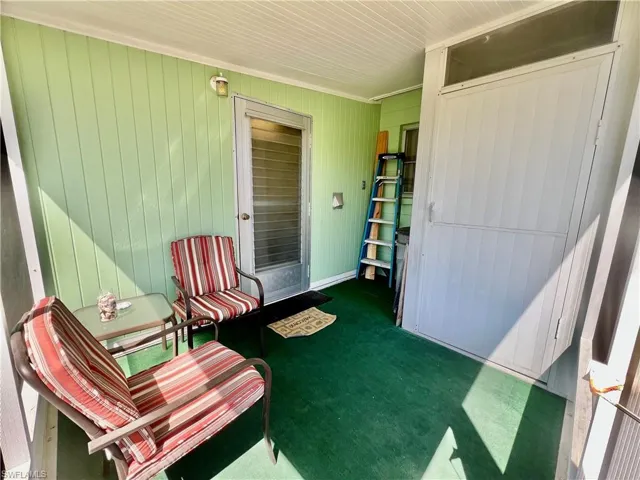 View of screened lanai with storage shed.