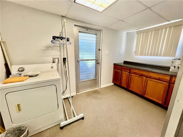 Laundry room with washer / dryer with  cabinet and counter space