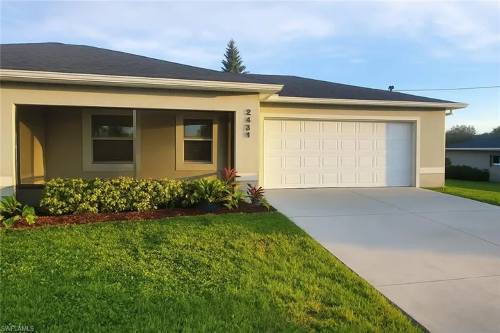Single story home with stucco siding, concrete driveway, an attached garage, and a front lawn