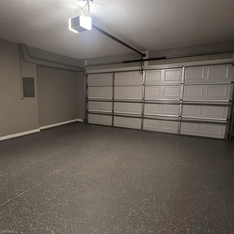Garage with electric panel and a garage door opener