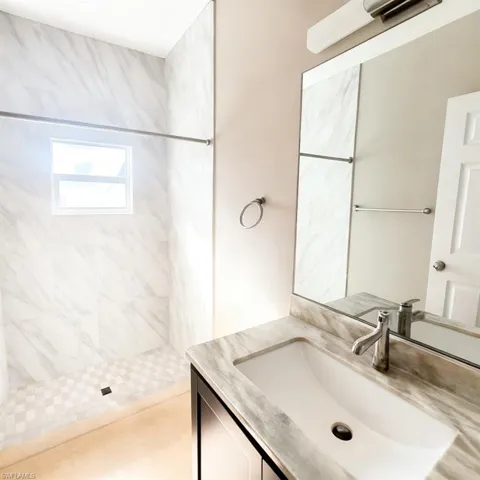 Bathroom featuring vanity and a shower stall