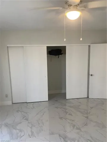 Unfurnished bedroom with ceiling fan