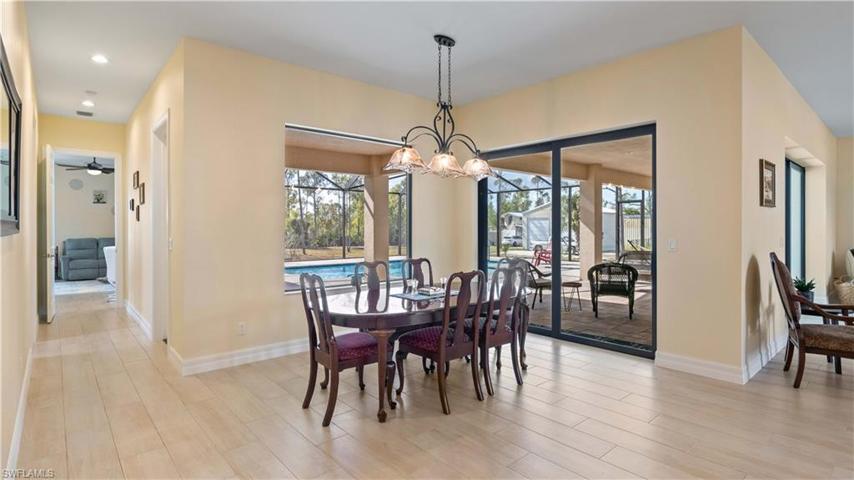 Dining area with beautiful lighting from Brothers - not only are there gorgeous views from the dining area but it can easily accommodate a larger table and there is plenty of space on the wall for buffet table!