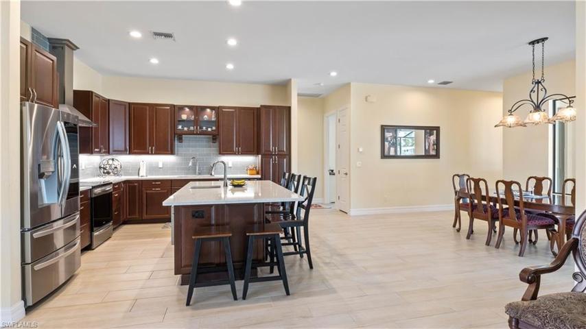 Calling all chefs!  Kitchen is centered around the large island with plenty of room for everyone to gather!  Open to the dining and the living area and beautiful views out to the pool!