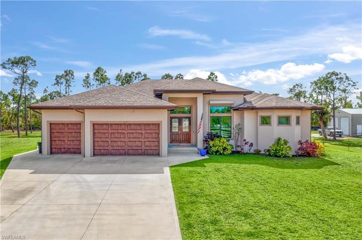 Daylight view of the home - large three car garage and a L O N G extended driveway!  Plenty of room for multiple and large vehicles including an RV!