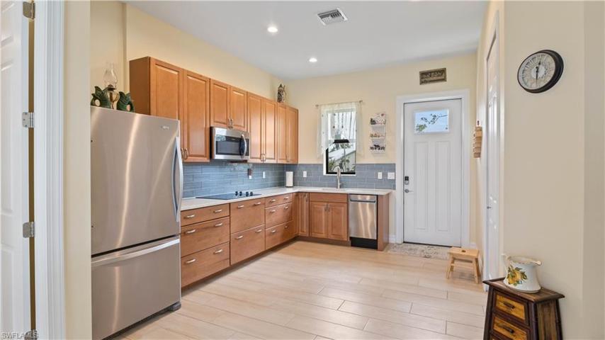 In-law guest home with private entrance, custom cabinets and eating kitchen!  Large spaces for wheelchair accessibility if needed - there are so many options for utilization including space for a nanny, or a professional office setup, a home daycare for the kids etc etc etc.