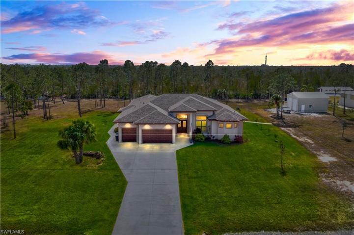 Twilight view of this home and the pole barn on the right.  Featuring 3 Bedrooms and an office, 3 car garage AND an additional attached FULL guest house with private entrance, this could be the perfect setup for a dual family and maintain privacy!