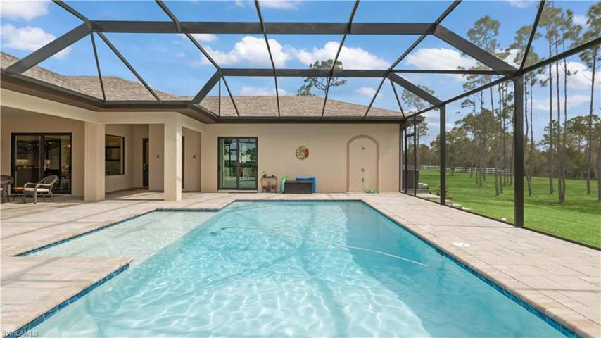 Supersized pool, supersized home, supersized lot!  Picture window reinforced screens to maximize the view!  Enjoy the pool year round and our average winter temperatures of 74 degrees!!