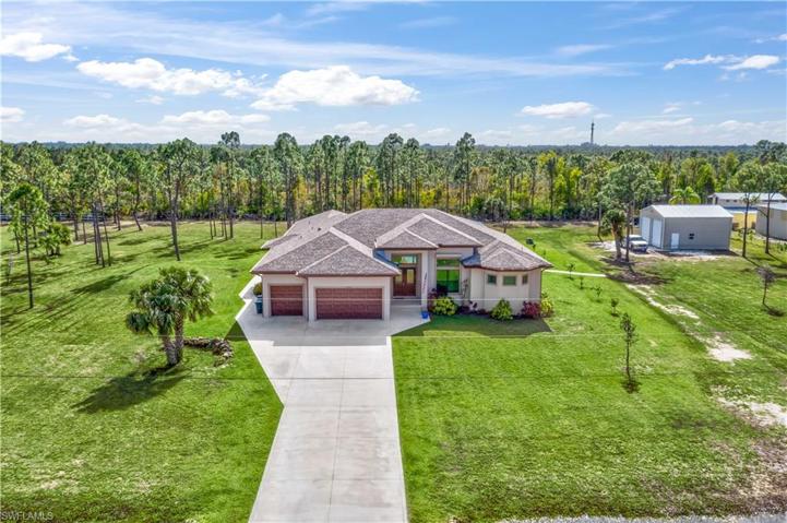 Daylight view of this gorgeous home - so much room for so many toys!  The pole barn to the right is 30 x 26 with plenty of room on the property to add more buildings, including a warehouse, horse barns and so much more...so many options!