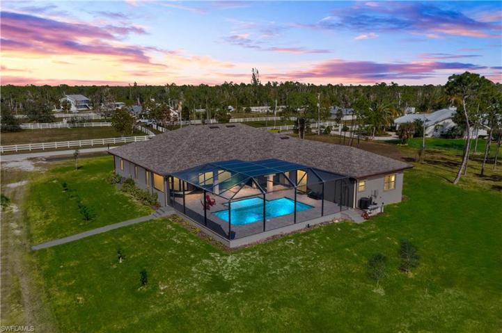 Twilight view of this beautiful home - pool is HUUUUGE!!!  LED multi-color pencil lights for ambience, Hayward programmable, Wi-Fi enabled interface remote with MaxFlo variable speed pump.  Salt water with electric heater - not only is the pool beautiful to look at, it is high performance operationally!