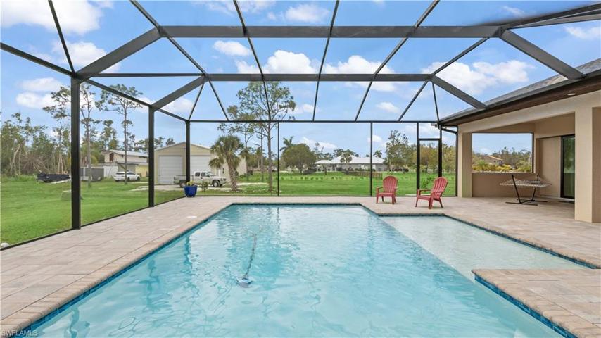Sparkling **SALTWATER** heated pool with large sunning ledge and TONS of covered outdoor space!  Reinforced and upgraded pool cage, super packed pavers and a pure outdoor oasis!  South facing to get the best sun and also the perfect set  up to kick back and watch the sunset from the west!
