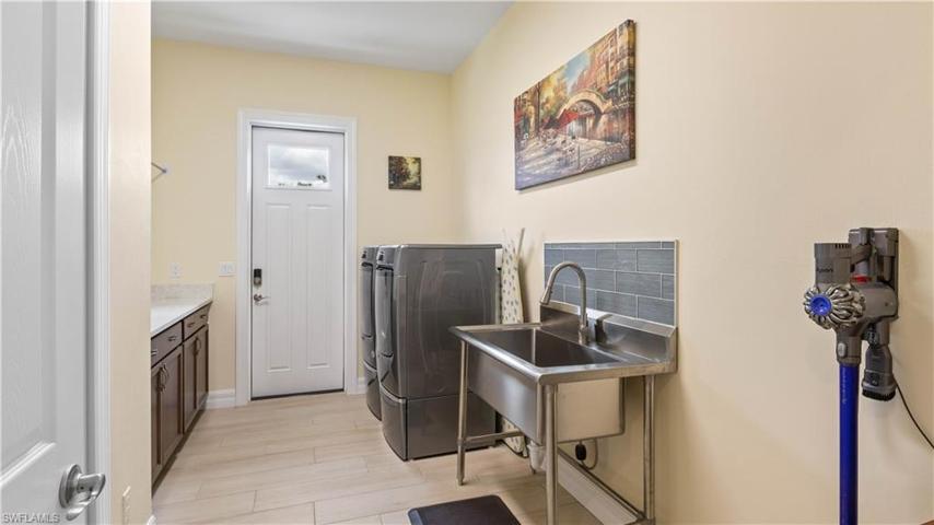 Not very often we highlight a laundry room but this one is both functional and fun - tons of additional storage space, an oversized free standing laundry tub and private access to the outside - and plenty of room to add additional storage!