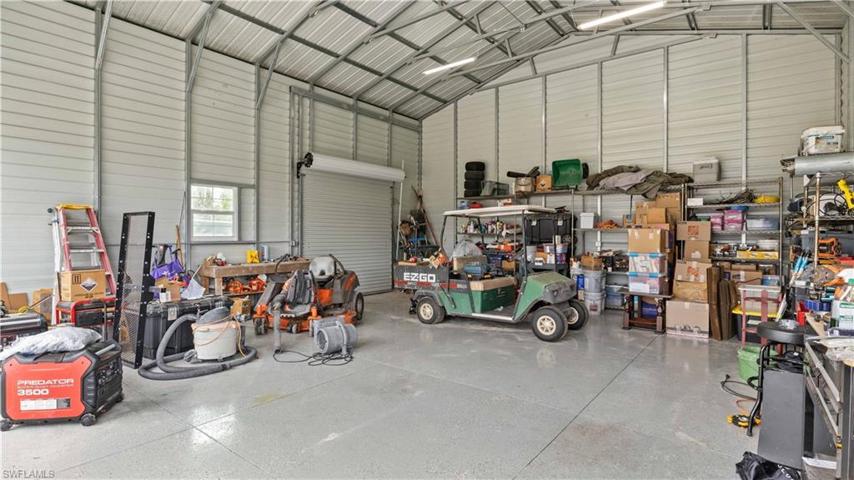 Very soundly built and NO FLOODING during Ian, this property sits up high and has very reasonable insurance with NO FLOOD required by Lender.  Ceilings are 16 foot tall, three rollup doors as well as side entry door and epoxy floors!