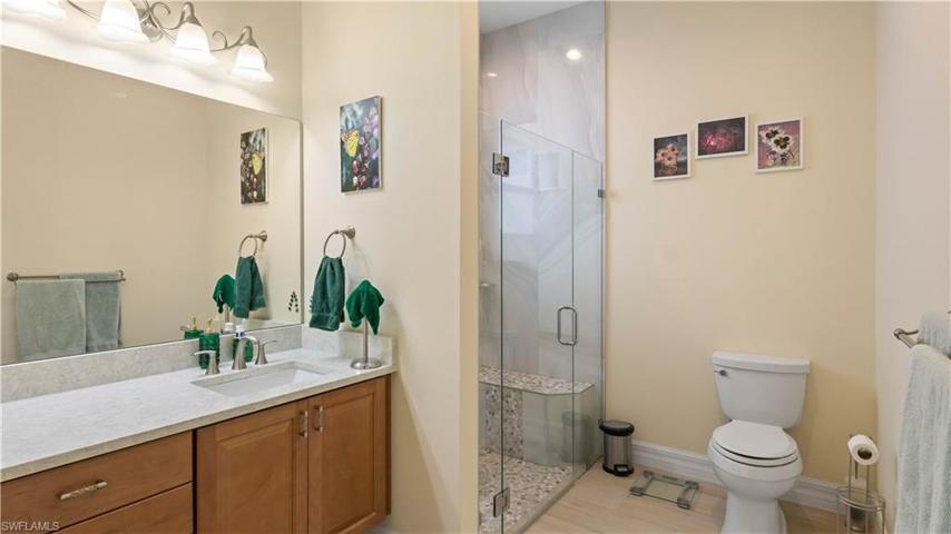 Guest Home bathroom designed to be ADA compliant - large doors, raised vanity and there is a large sit down bench in the shower.