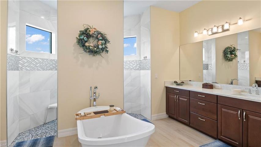 Master Bath is truly spacious and easily accessible - there are also two large walk in closets with all wood shelving (same throughout the home) and a private water closet.