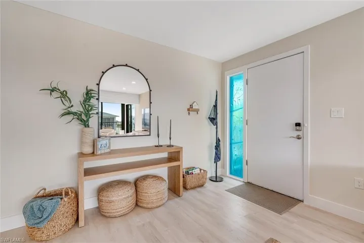 Foyer featuring light wood-style flooring and baseboards
