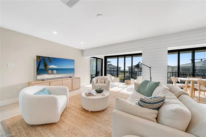 Living area featuring wood finished floors and recessed lighting