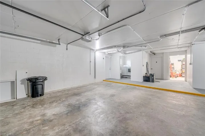 Garage with concrete block wall and a garage door opener