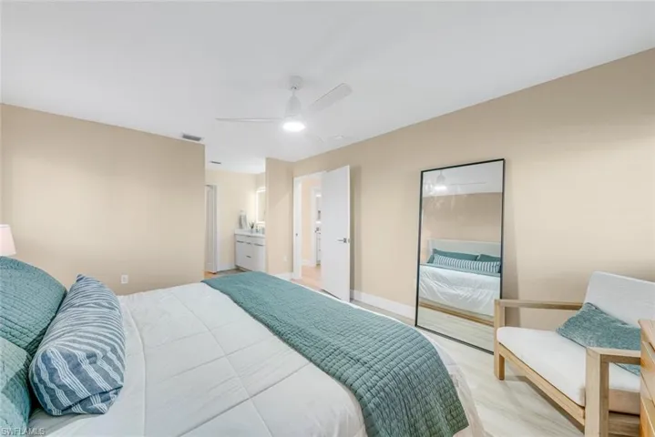 Bedroom with ceiling fan and light wood-style floors