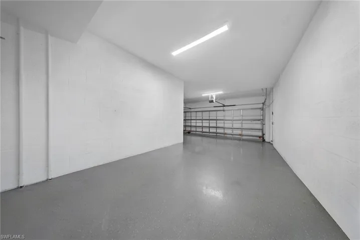 Garage featuring concrete block wall