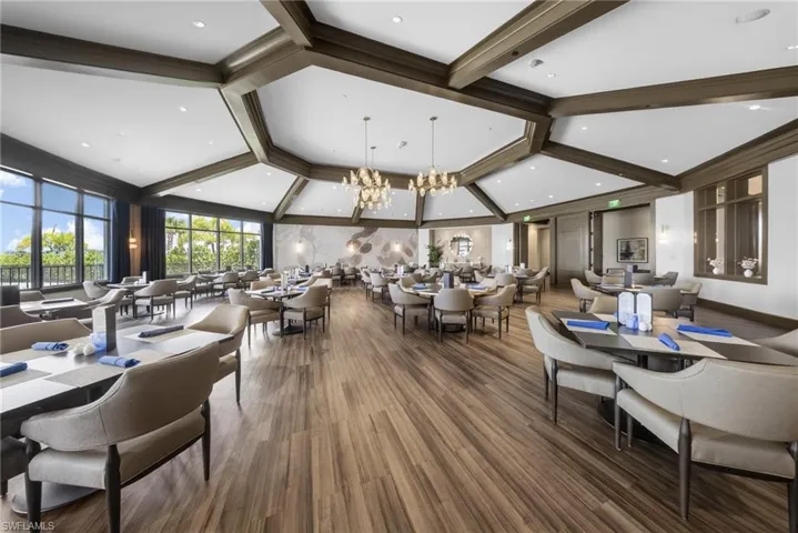 Dining space with hanging lights and dark wood finished floors