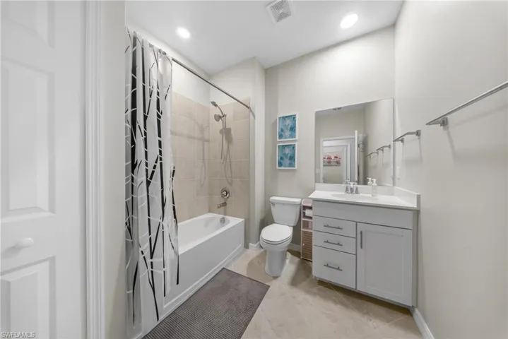 Full bath with vanity and shower / bath combination with curtain