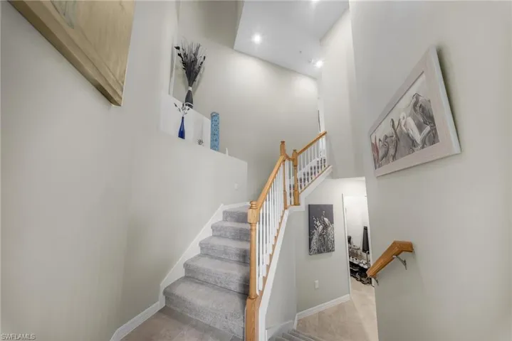 Stairway with a high ceiling and recessed lighting