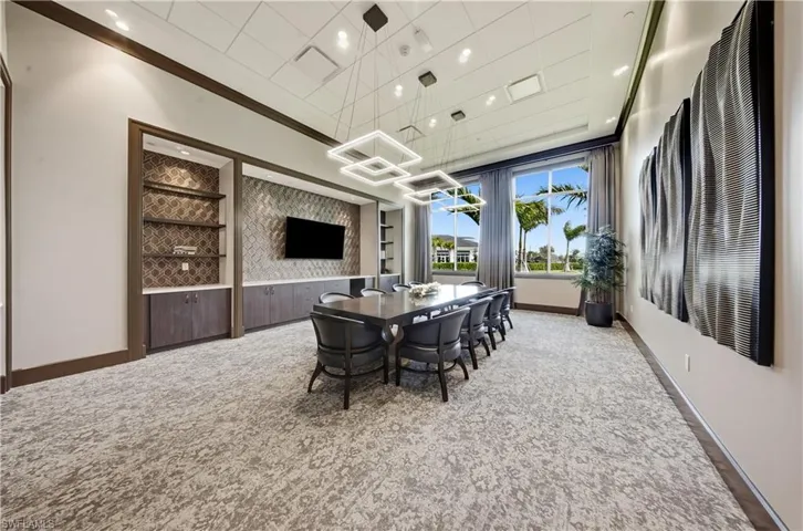 Dining room with carpet floors, crown molding, and recessed lighting