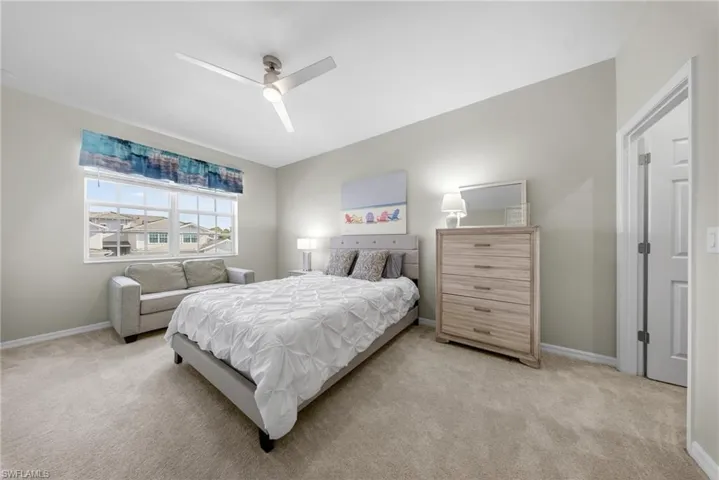 Bedroom featuring light carpet and a ceiling fan