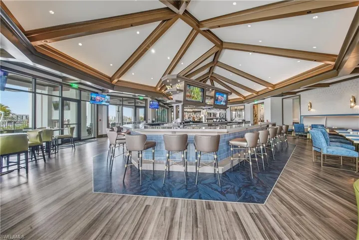 Bar featuring recessed lighting and a high ceiling