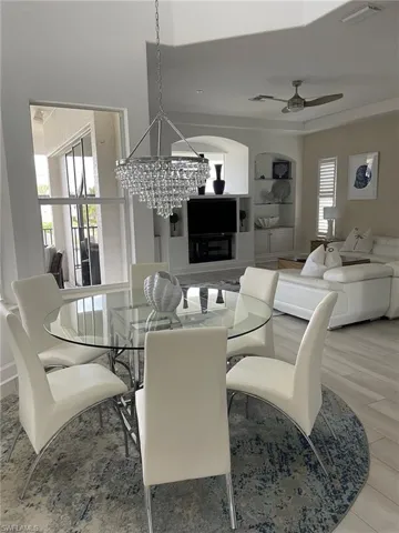 Dining room with ceiling fan and a chandelier